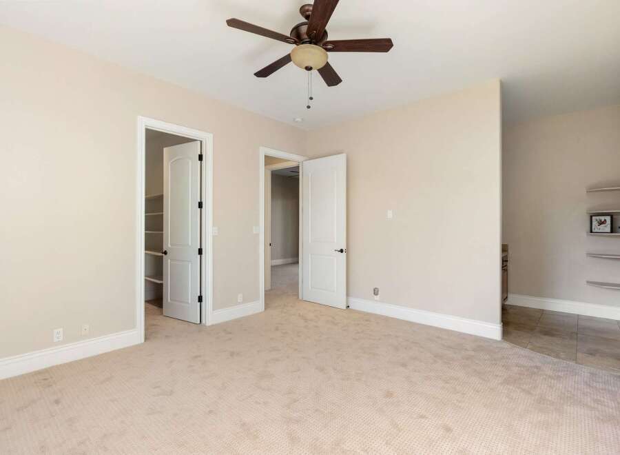 This spacious room features a neutral color palette, creating a bright and inviting atmosphere.