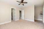 This spacious room features a neutral color palette, creating a bright and inviting atmosphere.