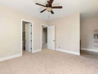 This spacious room features a neutral color palette, creating a bright and inviting atmosphere.