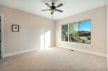 This spacious room offers a serene atmosphere with its neutral color palette and abundant natural light.