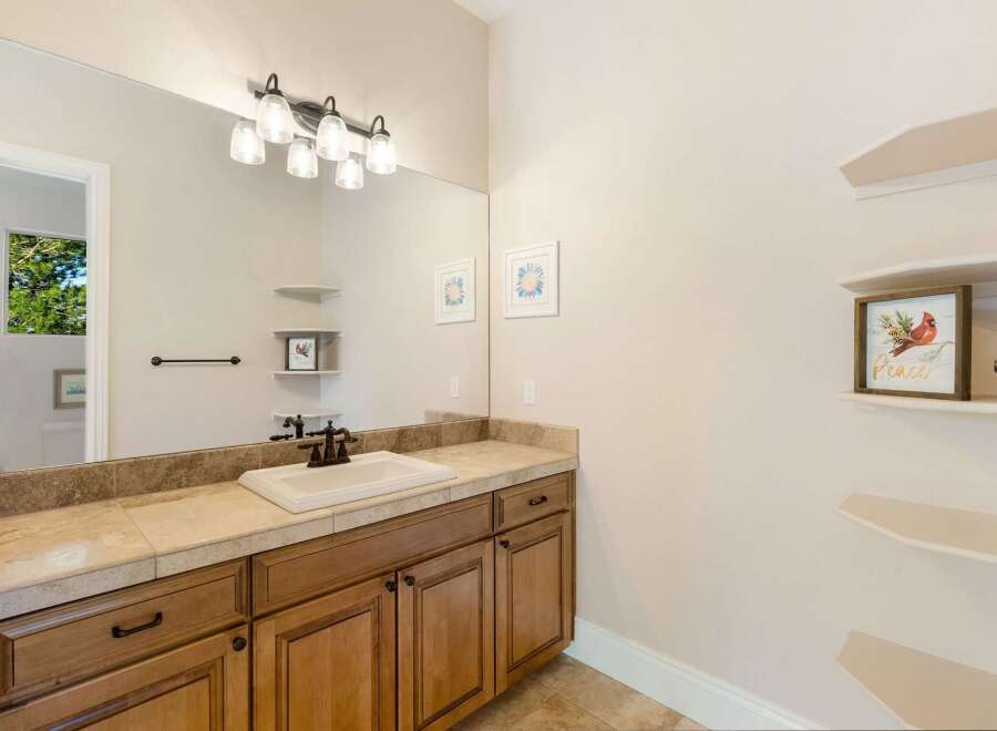 This beautiful bathroom features a stylish vanity with ample storage and a sleek countertop.