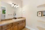 This beautiful bathroom features a stylish vanity with ample storage and a sleek countertop.