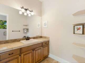 This beautiful bathroom features a stylish vanity with ample storage and a sleek countertop.