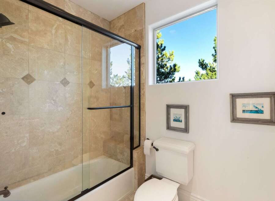 This stunning bathroom features a luxurious walk-in shower with a glass door, complemented by elegant tile work.
