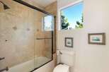 This stunning bathroom features a luxurious walk-in shower with a glass door, complemented by elegant tile work.