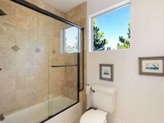 This stunning bathroom features a luxurious walk-in shower with a glass door, complemented by elegant tile work.