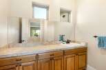 This stunning bathroom features a large mirror, perfect for getting ready in the morning.