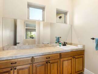 This stunning bathroom features a large mirror, perfect for getting ready in the morning.