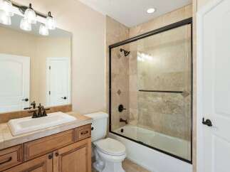 This beautiful bathroom features a modern design with a spacious vanity and a sleek shower.