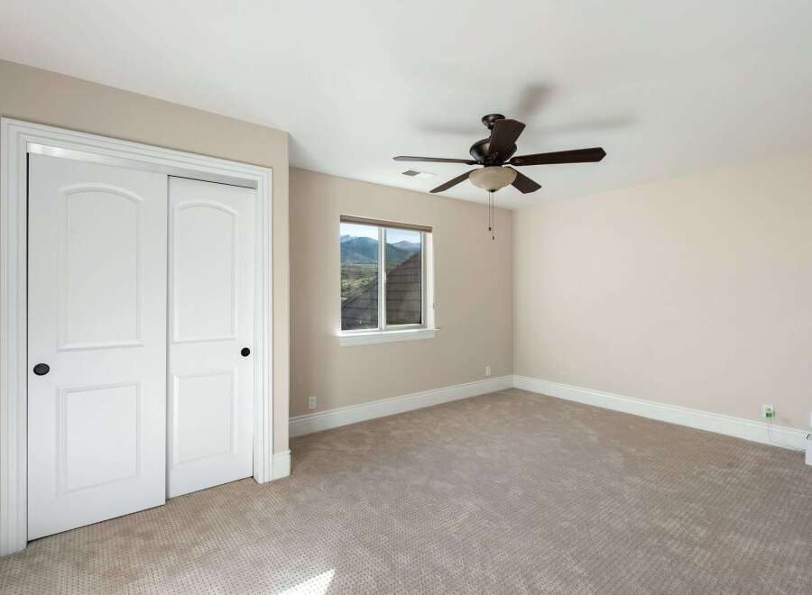 This inviting bedroom features a neutral color palette, creating a serene and relaxing atmosphere.