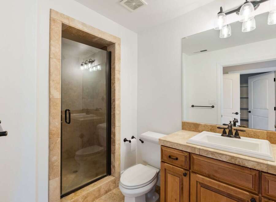 Step into a beautifully designed bathroom featuring a spacious walk-in shower with a glass door and elegant tile surround.