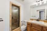 Step into a beautifully designed bathroom featuring a spacious walk-in shower with a glass door and elegant tile surround.