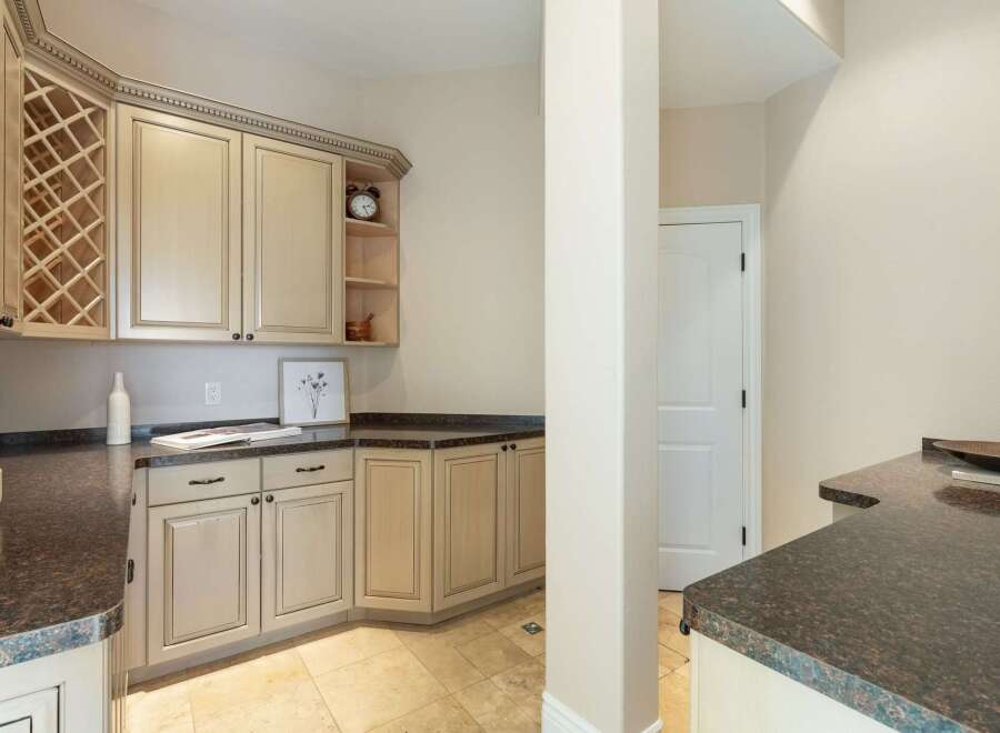 This stunning kitchen boasts elegant cabinetry, perfect for storage and organization.