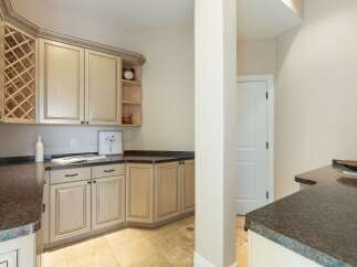 This stunning kitchen boasts elegant cabinetry, perfect for storage and organization.