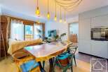 Experience the charm of this stunning property, featuring a beautifully designed dining area with a unique wooden table and stylish chairs.