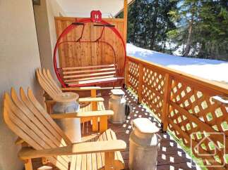 Enjoy the charm of this unique property with its ski lift-inspired seating and rustic wooden accents.