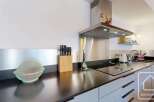 This modern kitchen boasts sleek stainless steel appliances and a stylish design.