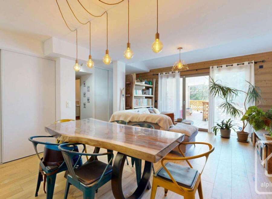Discover this stunning property featuring a spacious dining area with a unique wooden table and stylish chairs.