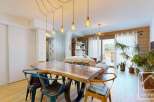 Discover this stunning property featuring a spacious dining area with a unique wooden table and stylish chairs.