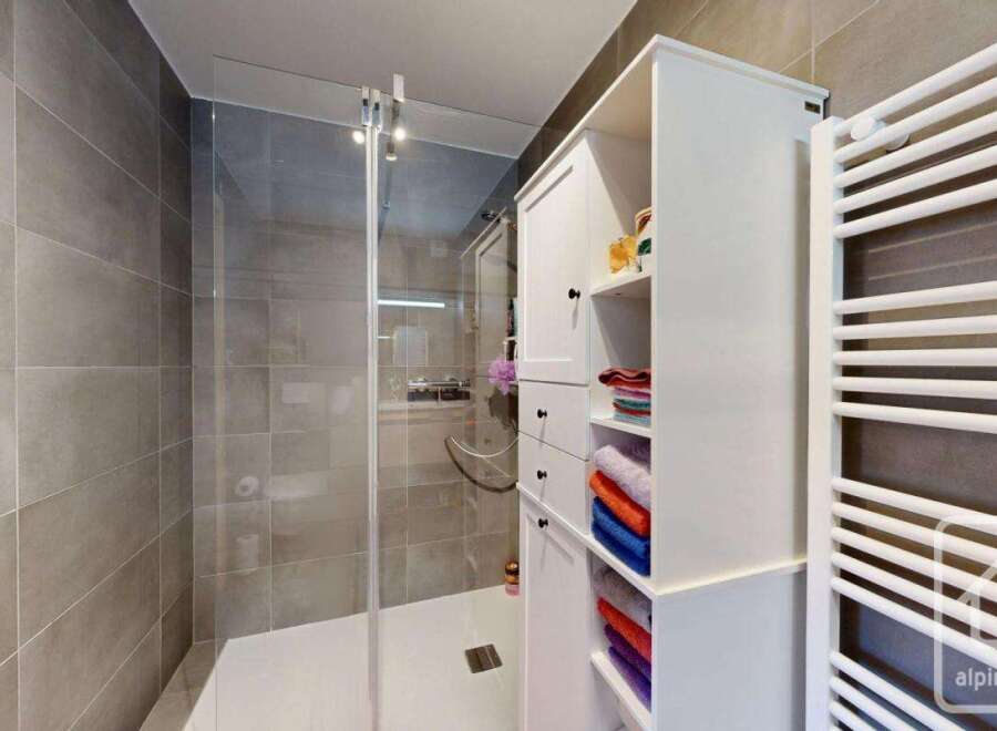 Step into a modern bathroom oasis! This stunning space features a sleek glass shower, perfect for a refreshing start to your day.