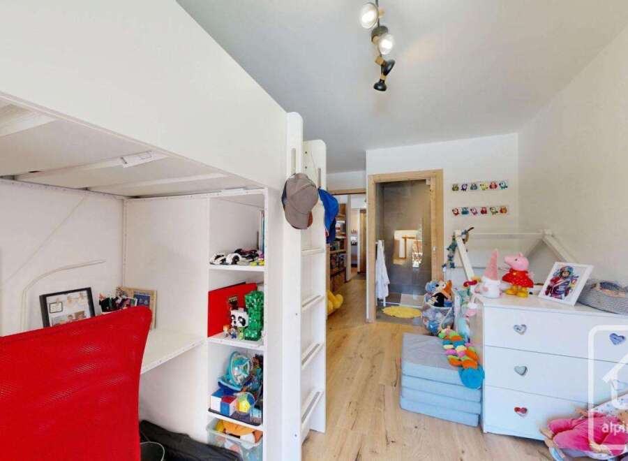 Discover this charming children's room, perfect for imaginative play and comfortable living.