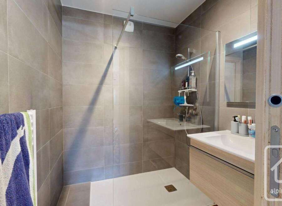Step into a modern bathroom oasis, featuring a sleek walk-in shower with glass enclosure.