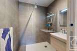 Step into a modern bathroom oasis, featuring a sleek walk-in shower with glass enclosure.