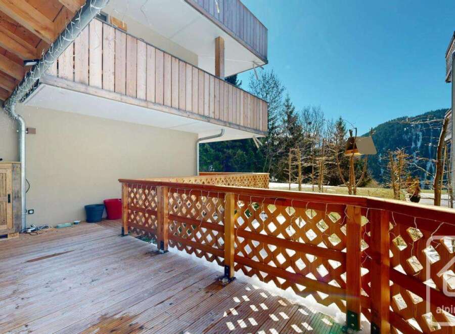 Enjoy stunning mountain views from this charming property featuring a spacious wooden deck and balcony.