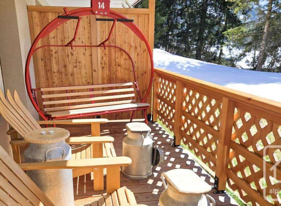 Enjoy the charm of this property with its unique ski lift swing and rustic wooden furniture.
