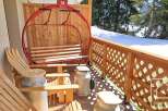 Enjoy the charm of this property with its unique ski lift swing and rustic wooden furniture.