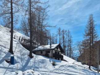 Nestled in a serene, snow-covered landscape, this charming property offers a perfect blend of tranquility and comfort.