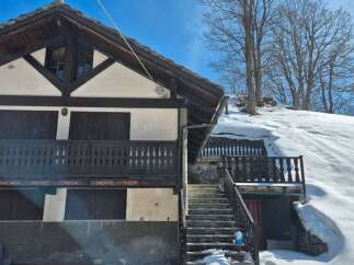 Discover the charm of this unique mountain chalet, nestled in a picturesque snowy landscape.