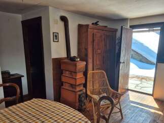 Step into a cozy retreat with this charming property, featuring a rustic interior and unique architectural details.