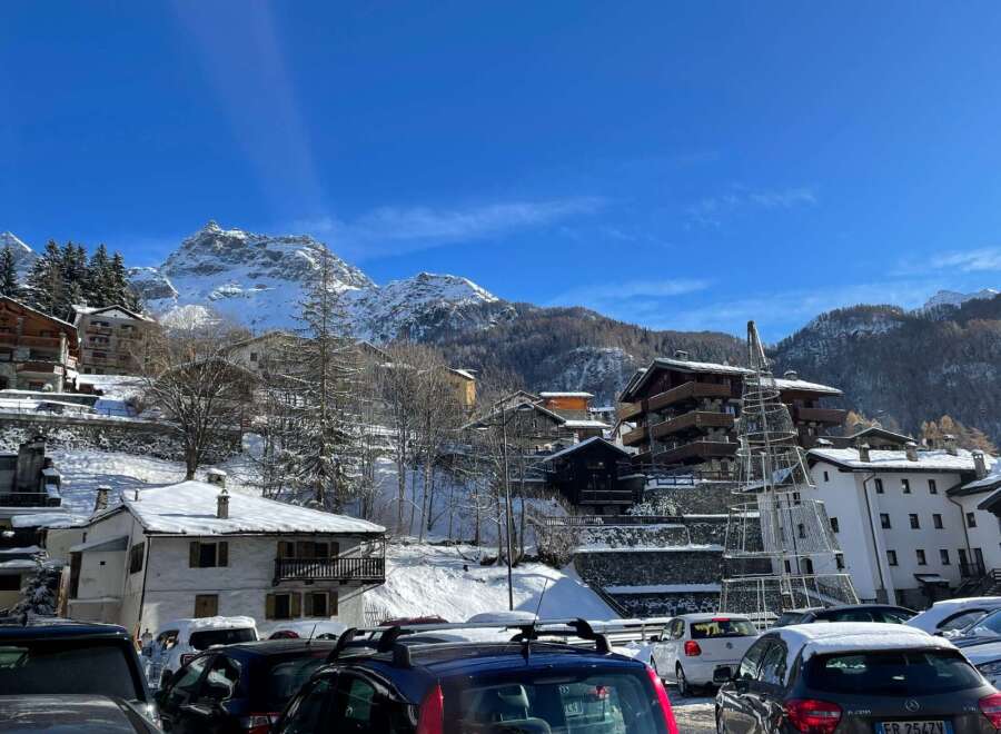 Discover the charm of mountain living in this picturesque village nestled amidst snow-capped peaks.
