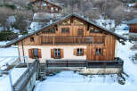 Discover a charming chalet nestled in a snowy landscape, perfect for a cozy retreat.