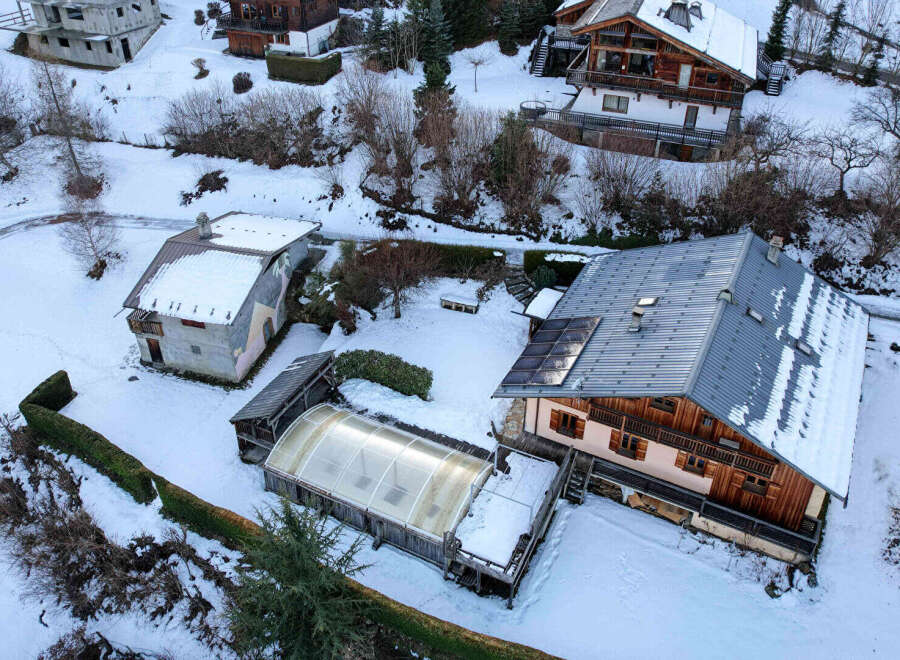 Discover a charming mountain retreat nestled in a snowy landscape.