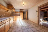 Step into this charming kitchen, featuring warm wooden cabinetry and a classic tile backsplash.