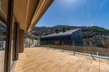 Experience luxury living with this stunning property featuring a spacious wooden deck and panoramic views.