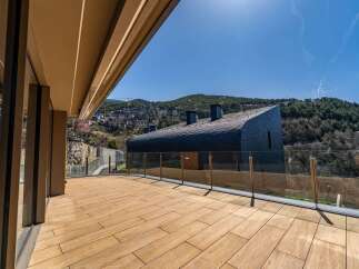 Experience luxury living with this stunning property featuring a spacious wooden deck and panoramic views.