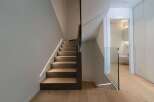 This stunning property features a modern staircase design with integrated lighting, creating a sleek and inviting atmosphere.