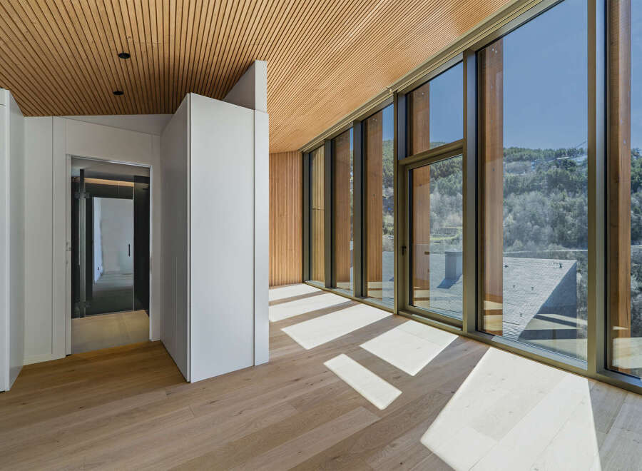 Experience luxury living in this stunning property, featuring a modern design with exquisite wooden accents.