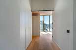 Experience modern elegance in this stunning property, featuring a bright hallway with beautiful wooden floors.