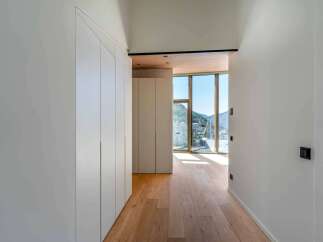 Experience modern elegance in this stunning property, featuring a bright hallway with beautiful wooden floors.