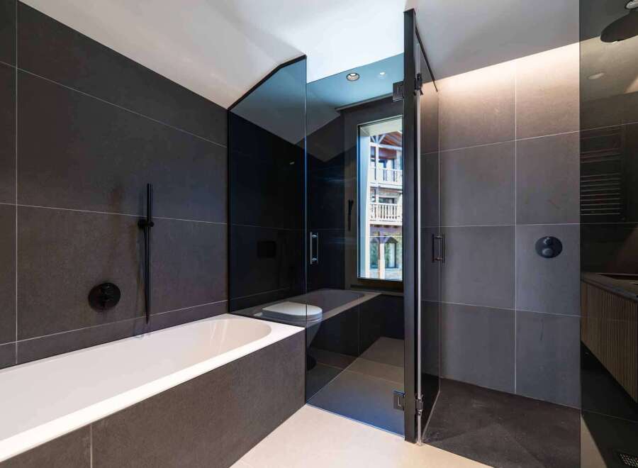 Step into luxury with this stunning bathroom featuring sleek, modern design.