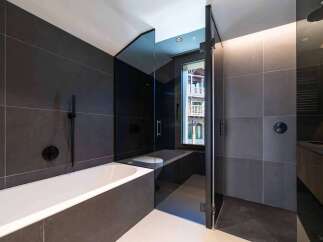 Step into luxury with this stunning bathroom featuring sleek, modern design.