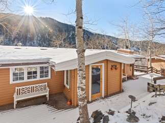 Nestled in a serene winter landscape, this charming cabin offers a cozy retreat.