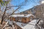 Nestled in a serene winter landscape, this charming cabin offers a cozy retreat.