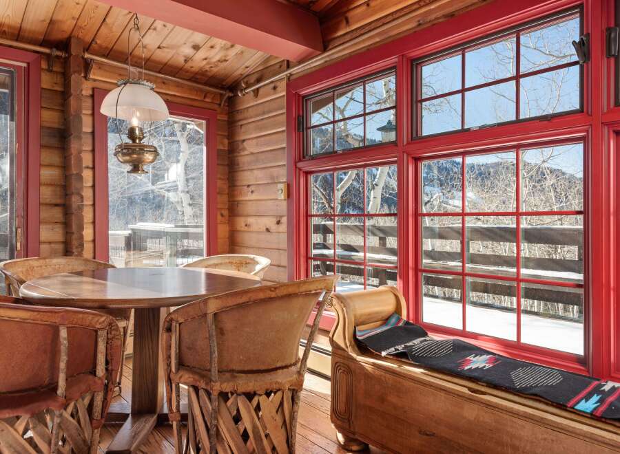 This charming cabin dining area features a rustic wooden table and chairs, perfect for enjoying meals with family and friends.