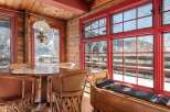 This charming cabin dining area features a rustic wooden table and chairs, perfect for enjoying meals with family and friends.