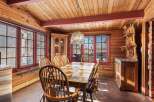 Step into this charming dining room, featuring a rustic wooden table and chairs, perfect for family gatherings.